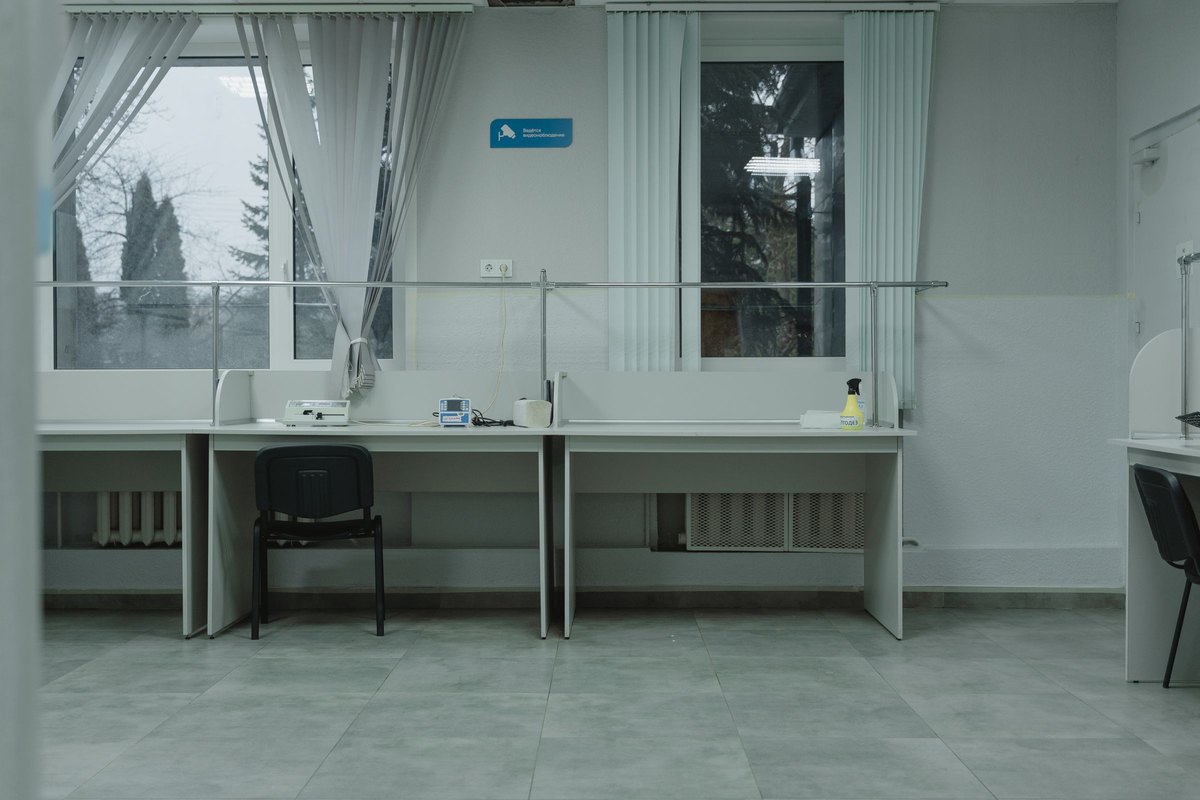 Clean, tidy office desk area with workstations and bright windows