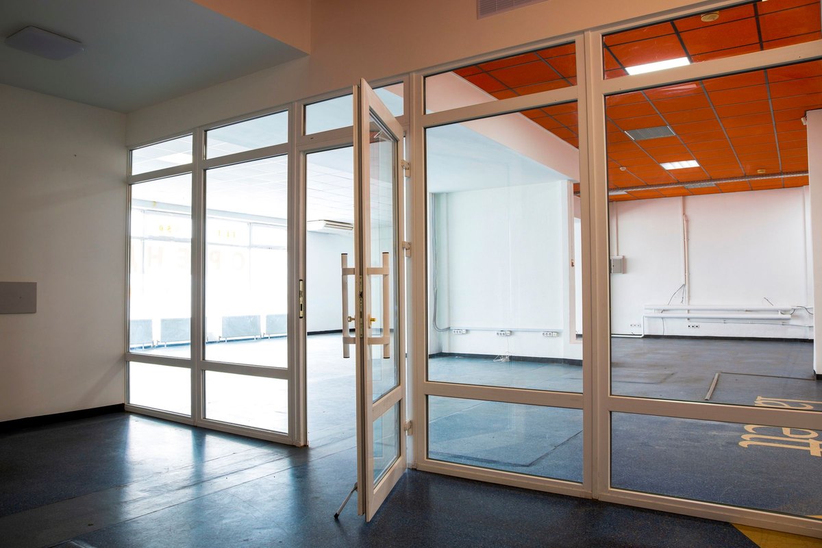 Empty, clean office unit with glass partition doors ready for handover